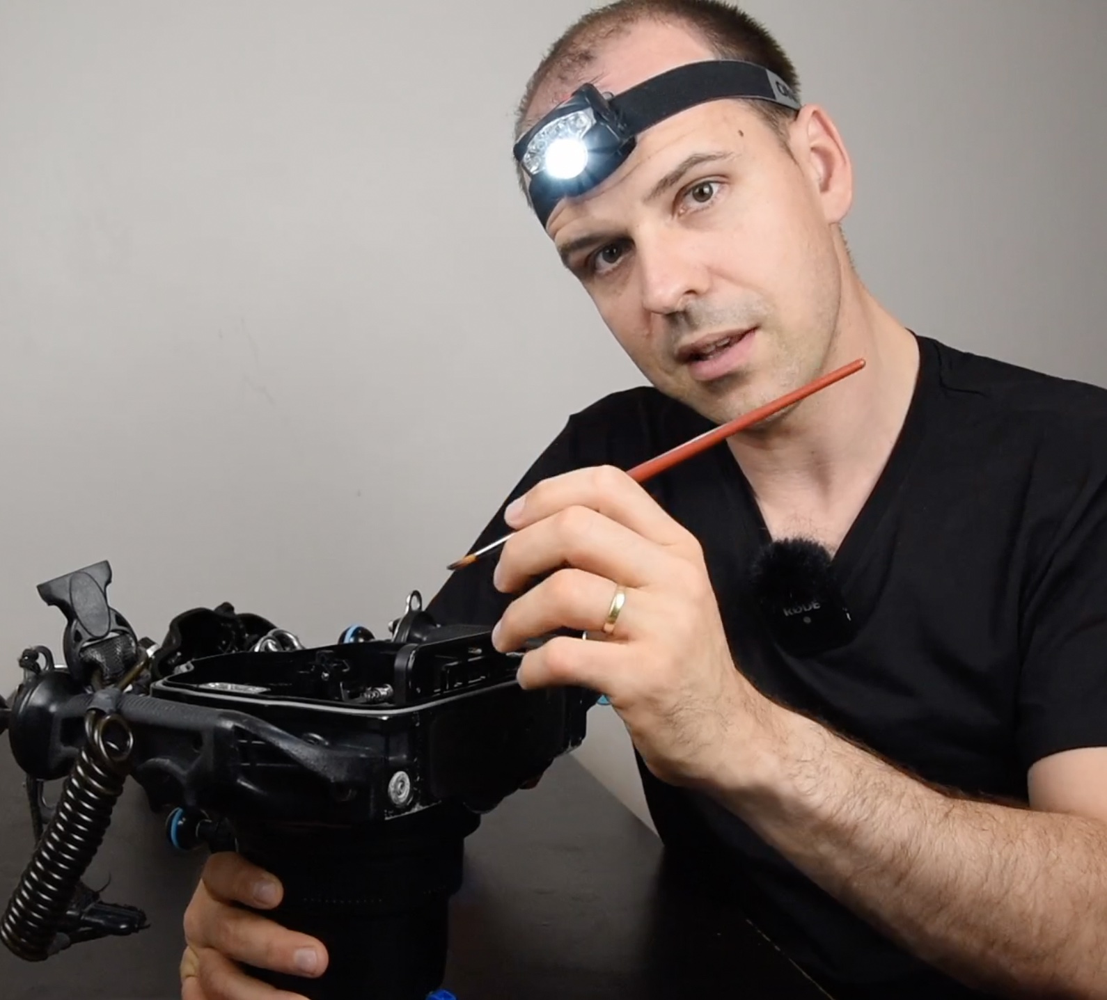 Nicolas REMY cleans sand from a nauticam camera housing o-ring